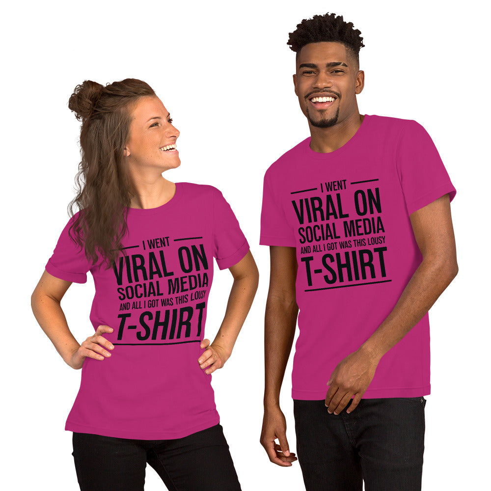 Two people wearing a shirt that reads, "I went viral on social media and all I got was this lousy t-shirt." The t-shirt is hot pink.