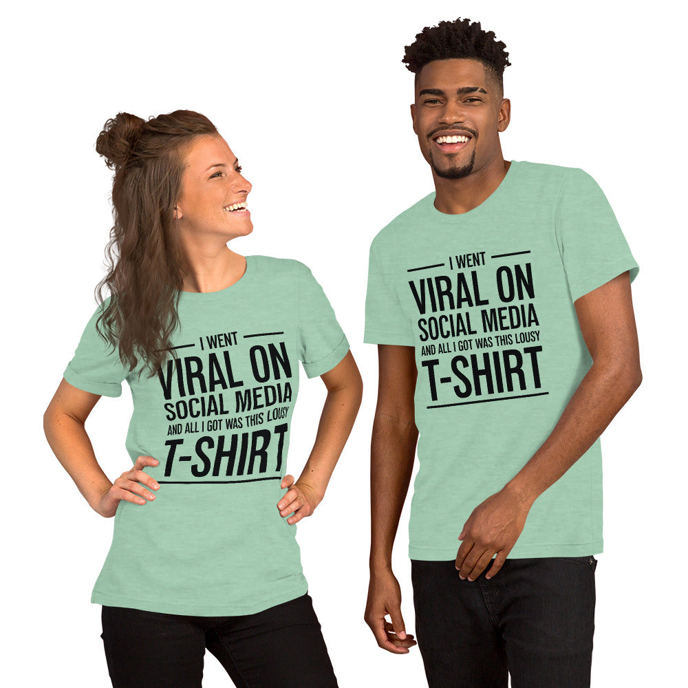 Two people wearing a shirt that reads, "I went viral on social media and all I got was this lousy t-shirt." The t-shirt is heather seafoam green.