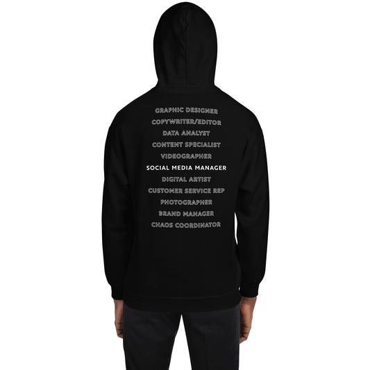 Back of a black hoodie that lists different roles that a social media manager plays. The extra roles are just outlined while Social Media Manger is bold and white.